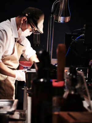 Chefs in a busy restaurant kitchen preparing dishes with precision and teamwork.